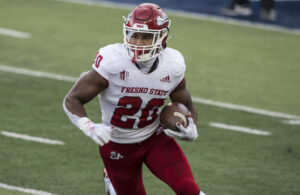 Ronnie Rivers #20 of the Fresno State Bulldogs rushes the ball against the Utah State Aggies during their game November 14, 2020 at Maverick Stadium in Logan, Utah.