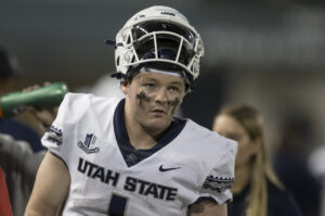 Logan Bonner #1 QB of Utah State looks on from the sideline. 