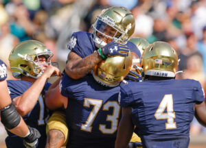 Several unidentified Notre Dame players celebrate a touchdown