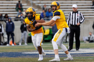 AKRON, OH - NOVEMBER 20: Kent State Golden Flashes running back Marquez Cooper (1) takes the ball from Kent State Golden Flashes quarterback Dustin Crum (7) in the third quarter during a Mid-American Conference game between the Akron Zips and the Kent State Golden Flashes on November 20, 2021 at Summa Field at InfoCision Stadium in Akron, Ohio.