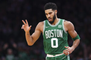 Jayson Tatum #0 of the Boston Celtics reacts after hitting a three-point shot during a game against the Milwaukee Bucks at TD Garden on December 13, 2021 in Boston, Massachusetts.