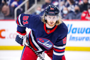 Kyle Connor #81 of the Winnipeg Jets gets set during a first period face-off against the Washington Capitals at the Canada Life Centre on December 17, 2021 in Winnipeg, Manitoba, Canada.