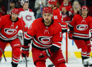 Nino Niederreiter #21 of the Carolina Hurricanes scores a power play goal and skates back to the bench to celebrate with teammates during an NHL game against the Montreal Canadiens on December 30, 2021 at PNC Arena in Raleigh, North Carolina.