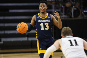 Chattanooga Mocs guard Malachi Smith (13) dribbles the ball down the court during a college basketball game against the Wofford Terriers