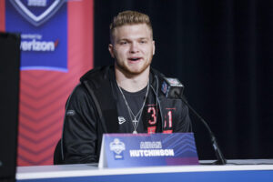 Aidan Hutchinson #DL31 of the Michigan Wolverines speaks to reporters during the NFL Draft Combine at the Indiana Convention Center on March 4, 2022 in Indianapolis, Indiana.