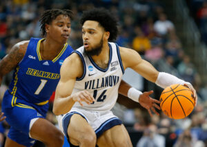 Caleb Daniels #14 of the Villanova Wildcats is defended by Kevin Anderson #1 of the Delaware Fightin Blue Hens during the first round of the 2022 NCAA Men's Basketball Tournament held at PPG PAINTS Arena on March 18, 2022 in Pittsburgh, Pennsylvania.