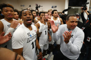 Head Coach Ed Cooley of the Providence Friars congratulates his team following their 79-51 victory against the Richmond Spiders during the second round of the 2022 NCAA Men's Basketball Tournament held at the KeyBank Center on March 19, 2022 in Buffalo, New York.