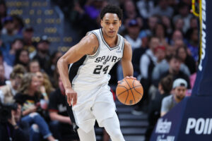 Devin Vassell #24 of the San Antonio Spurs handles the ball against the Denver Nuggets during the second quarter at Ball Arena on April 5, 2022 in Denver, Colorado.