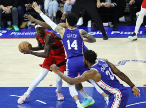 Toronto Raptors forward Pascal Siakam, left, looks to pass around the Philadelphia 76ers' James Harden, second from left, Danny Green, third from left, and Joel Embiid, right, on Monday, April 25, 2022, in Philadelphia.