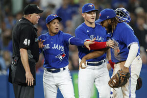 Toronto Blue Jays first baseman Vladimir Guerrero Jr., right, argues with umpire Ron Kulpa, left, as Toronto manager Charlie Montoyo, second from left, and third baseman Matt Chapman, second from right, try to intervene on Tuesday, May 3, 2022, in Toronto.