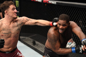 Tom Aspinall of England (left) connects with a left hand to the head of Alan Baudot of France (right) in a heavyweight bout during UFC Fight Night