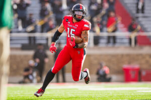 Tight end Travis Koontz #15 of the Texas Tech Red Raiders runs the ball during the first half of the college football game against the Baylor Bears at Jones AT&T Stadium on November 14, 2020 in Lubbock, Texas.