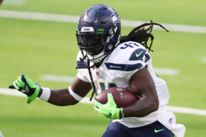 Seattle Seahawks running back #41 Alex Collins runs with the ball in a 2021 road game.