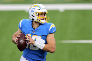 Los Angeles quarterback #10 Justin Herbert looks for a receiver in a 2021 home game.