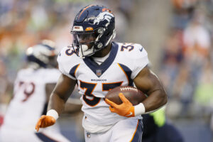 Running back Javonte Williams #33 of the Denver Broncos carries the ball in the first half during an NFL preseason game against the Seattle Seahawks at Lumen Field on August 21, 2021 in Seattle, Washington. The Denver Broncos beat the Seattle Seahawks 30-3.