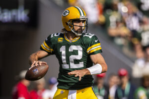 Green Bay quarterback #12 Aaron Rodgers looks downfield in a 2021 home game.