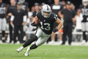 Wide receiver Hunter Renfrow #13 of the Las Vegas Raiders runs with the football against the Miami Dolphins during the NFL game at Allegiant Stadium on September 26, 2021 in Las Vegas, Nevada. The Raiders defeated the Dolphins 31-28 in overtime.