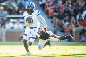 Quarterback Darren Grainger #3 of the Georgia State Panthers runs the ball by defensive end T.D. Moultry #99 of the Auburn Tigers at Jordan-Hare Stadium on September 25, 2021 in Auburn, Alabama.