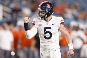 Virginia QB Brennan Armstrong completes a pass in a 2021 road game.