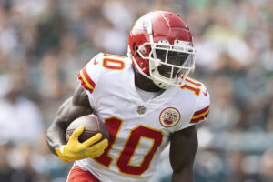 Kansas City Chiefs wide receiver #10 Tyreek Hill turns upfield for running room in a 2021 road game.