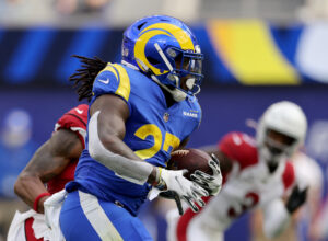 Los Angeles Rams running back #27 Darrell Henderson tries to find running room in a 2021 home game against the Arizona Cardinals.