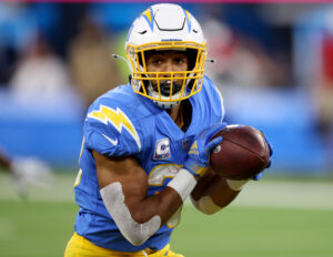 Los Angeles Chargers running back #30 Austin Ekeler looks upfield for running room in a 2021 home game.