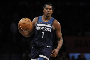 Minnesota Timberwolves guard Anthony Edwards brings the ball up the court in a 2021 game.