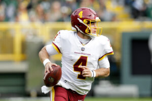 Taylor Heinicke #4 of the Washington Football Team looks to pass against the Green Bay Packers at Lambeau Field on October 24, 2021 in Green Bay, Wisconsin. Green Bay defeated Washington 24-10.