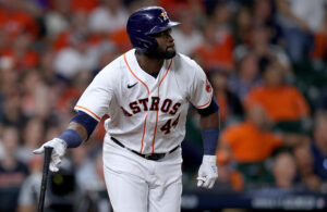 Yordan Alvarez #44 of the Houston Astros hits a triple against the Atlanta Braves during the eighth inning in Game One of the World Series at Minute Maid Park on October 26, 2021 in Houston, Texas.