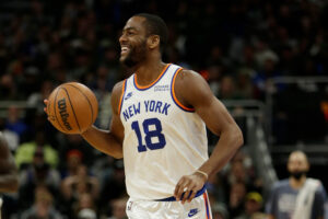 Alec Burks #18 of the New York Knicks smiles as he brings the ball up court in the final minutes of the game at Fiserv Forum on November 05, 2021 in Milwaukee, Wisconsin. Knicks defeated the Bucks 113-98.