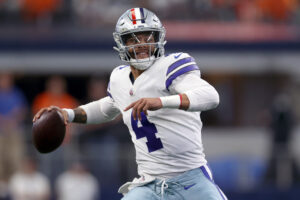 Dak Prescott #4 of the Dallas Cowboys scrambles with the ball during the first quarter against the Denver Broncos at AT&T Stadium on November 07, 2021 in Arlington, Texas