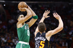  Jayson Tatum #0 of the Boston Celtics shoots over Duncan Robinson #55 of the Miami Heat during the second half at FTX Arena on November 04, 2021 in Miami, Florida.