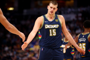 Nikola Jokic #15 of the Denver Nuggets gives high fives against the Houston Rockets at Ball Arena on November 6, 2021 in Denver, Colorado.