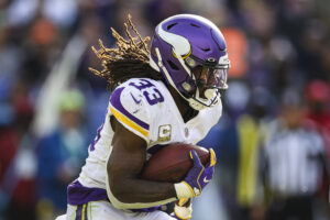 Dalvin Cook #33 of the Minnesota Vikings carries the ball against the Baltimore Ravens during the first half at M&T Bank Stadium on November 7, 2021 in Baltimore, Maryland.