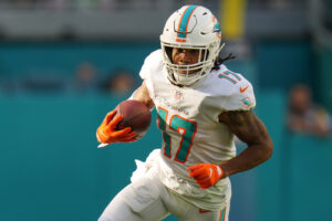 Jaylen Waddle #17 of the Miami Dolphins runs with the ball after making a catch against the Houston Texans at Hard Rock Stadium on November 07, 2021 in Miami Gardens, Florida.