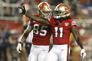 Brandon Aiyuk #11 celebrates with teammate George Kittle #85 of the San Francisco 49ers after getting a touchdown in the second half of the game against the Los Angeles Rams at Levi's Stadium on November 15, 2021 in Santa Clara, California.