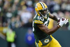 Marquez Valdes-Scantling #83 of the Green Bay Packers runs with the ball against the Seattle Seahawks in the first half at Lambeau Field on November 14, 2021 in Green Bay, Wisconsin.