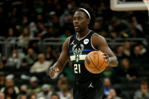 Jrue Holiday #21 of the Milwaukee Bucks dribbles the basketball up court during the first half of the game against the Oklahoma City Thunder at Fiserv Forum on November 19, 2021 in Milwaukee, Wisconsin. Bucks defeated the Thunder 96-89.