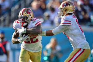 Jimmy Garoppolo #10 of the San Francisco 49ers hands the ball to Jeff Wilson Jr. #22 during the fourth quarter against the Jacksonville Jaguars at TIAA Bank Field on November 21, 2021 in Jacksonville, Florida. 