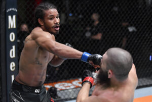 Darian Weeks (left) delivers a straight right-hand punch to the face of Bryan Barberena in their welterweight fight during the UFC Fight Night event at UFC APEX