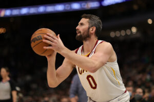 Kevin Love #0 of the Cleveland Cavaliers takes a three point shot during the second half of a game against the Milwaukee Bucks at Fiserv Forum on December 06, 2021 in Milwaukee, Wisconsin. 