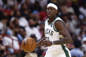 Jrue Holiday #21 of the Milwaukee Bucks dribbles the ball up the court against the Miami Heat during the second half at FTX Arena on December 08, 2021 in Miami, Florida.