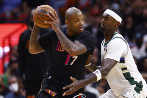 Miami Heat forward P.J. Tucker (left) is defended by Milwaukee Bucks center Bobby Portis