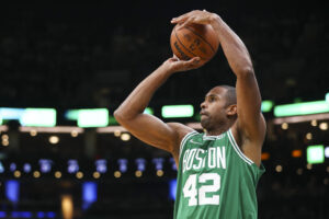 Al Horford #42 of the Boston Celtics shoots the ball during a game against the Milwaukee Bucks at TD Garden on December 13, 2021 in Boston, Massachusetts.