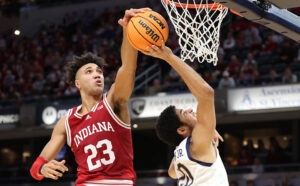 Trayce Jackson-Davis #23 of the Indiana Hoosiers blocks the shot of Paul Atkinson Jr #20 of the Notre Dame Fighting Irish during the 2021 Crossroads Classic at Gainbridge Fieldhouse on December 18, 2021 in Indianapolis, Indiana. 