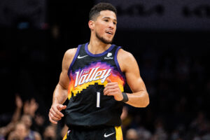 Devin Booker #1 of the Phoenix Suns reacts after making a shot against the Charlotte Hornets in the first quarter during their game at Spectrum Center on January 02, 2022 in Charlotte, North Carolina.