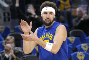 Klay Thompson #11 of the Golden State Warriors walks onto the court clapping to warm up prior to the start of his game against the Cleveland Cavaliers at Chase Center on January 09, 2022 in San Francisco, California.