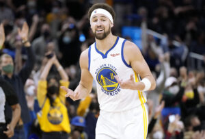 Klay Thompson #11 of the Golden State Warriors reacts after scoring on a three-point shot against the Cleveland Cavaliers during the second quarter at Chase Center on January 09, 2022 in San Francisco, California.