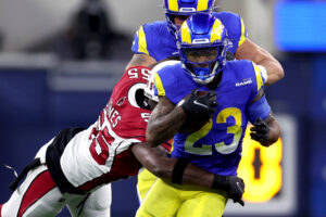 Cam Akers #23 of the Los Angeles Rams is tackled by Chandler Jones #55 of the Arizona Cardinals in the second quarter of the NFC Wild Card Playoff game at SoFi Stadium on January 17, 2022 in Inglewood, California.