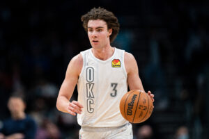 Josh Giddey #3 of the Oklahoma City Thunder brings the ball up court against the Charlotte Hornets during their game at Spectrum Center on January 21, 2022 in Charlotte, North Carolina. 